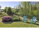 Fenced backyard has lush landscaping and a seating area, creating a serene retreat at 5035 Castlegate Ct, Cumming, GA 30040