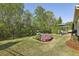 Landscaped backyard features a patio set, lawn, iron fence, and beautiful plantings at 5035 Castlegate Ct, Cumming, GA 30040