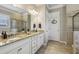 Bathroom featuring double sinks, granite countertops, tile floors, a glass shower, and a soaking tub at 5035 Castlegate Ct, Cumming, GA 30040