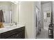 Bright bathroom featuring a white vanity, tiled floor, and shower/tub combo at 5035 Castlegate Ct, Cumming, GA 30040