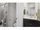 The half-bath features a sleek vanity, neutral walls and a decorative shower at 5035 Castlegate Ct, Cumming, GA 30040