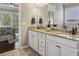 Bathroom with granite countertops, double sinks, and view to the Primary bedroom at 5035 Castlegate Ct, Cumming, GA 30040
