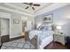 Bedroom with blue walls, white trim, ceiling fan, dark wood floors, and a queen-size bed with blue and white linens at 5035 Castlegate Ct, Cumming, GA 30040