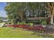 Community entrance to Kingswood featuring flowers, plants, trees and grass at 5035 Castlegate Ct, Cumming, GA 30040