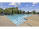Large community pool with blue umbrellas and blue lounge chairs at 5035 Castlegate Ct, Cumming, GA 30040