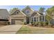 Charming home exterior showcasing mixed brick and stone, complemented by a well-manicured lawn and landscape at 5035 Castlegate Ct, Cumming, GA 30040