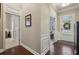 Hallway featuring beautiful hardwood floors, white trim and access to other rooms at 5035 Castlegate Ct, Cumming, GA 30040