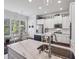 Eat-in kitchen features white cabinets and countertops plus stainless steel appliances at 5035 Castlegate Ct, Cumming, GA 30040