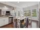 Eat-in kitchen with island seating and stainless steel appliances overlooks the well landscaped yard at 5035 Castlegate Ct, Cumming, GA 30040