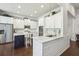 Gourmet kitchen features white cabinets, stainless steel appliances and light countertops at 5035 Castlegate Ct, Cumming, GA 30040