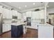 Bright kitchen featuring white cabinets, stainless steel appliances and a contrasting dark island at 5035 Castlegate Ct, Cumming, GA 30040