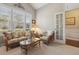 Cozy living room with natural light from the large windows and neutral carpeting at 5035 Castlegate Ct, Cumming, GA 30040