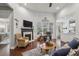 Open-concept living space featuring hardwood floors, fireplace and modern decor at 5035 Castlegate Ct, Cumming, GA 30040