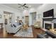 Spacious living room with hardwood floors, fireplace, and views to other areas at 5035 Castlegate Ct, Cumming, GA 30040