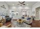 Bright living area open to the kitchen and dining room, featuring hardwood floors at 5035 Castlegate Ct, Cumming, GA 30040