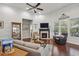 Cozy living area with fireplace, ceiling fan, and comfortable seating arrangement at 5035 Castlegate Ct, Cumming, GA 30040