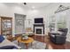 Bright living room with fireplace, hardwood floors, and plenty of natural light at 5035 Castlegate Ct, Cumming, GA 30040