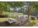 Community tennis courts with a picnic table, a bench, and green space surrounding the courts at 5035 Castlegate Ct, Cumming, GA 30040