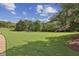 Expansive green lawn surrounded by mature trees, creating a peaceful and inviting outdoor space at 5035 Castlegate Ct, Cumming, GA 30040