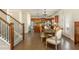 Inviting dining area with hardwood floors, a view into the kitchen, and staircase access at 5390 Chestnut Dr, Cumming, GA 30040