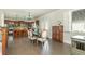 Open-concept dining area with hardwood floors, a large dining table, and a view into the kitchen at 5390 Chestnut Dr, Cumming, GA 30040