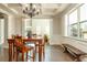Bright and airy dining room featuring hardwood floors, coffered ceilings, and a stylish chandelier at 5390 Chestnut Dr, Cumming, GA 30040