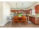 The kitchen features stainless appliances, granite countertops, and a center island with seating at 5390 Chestnut Dr, Cumming, GA 30040