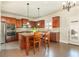 Kitchen features granite countertops, stainless appliances, and a center island with seating for two at 5390 Chestnut Dr, Cumming, GA 30040