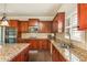 Kitchen features granite countertops, stainless appliances, and custom wood cabinetry at 5390 Chestnut Dr, Cumming, GA 30040