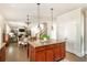 Open concept kitchen with granite island, kitchen island seating and view of fireplace in living room at 5390 Chestnut Dr, Cumming, GA 30040