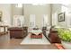 Elegant living room with soaring ceilings, plantation shutters, and a comfortable leather sofa at 5390 Chestnut Dr, Cumming, GA 30040