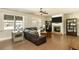 Bright living room with a stone fireplace, built-in shelves, hardwood floors, and plenty of natural light at 5390 Chestnut Dr, Cumming, GA 30040