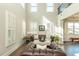 Elegant living room with soaring ceilings, plantation shutters, and a comfortable leather sofa at 5390 Chestnut Dr, Cumming, GA 30040