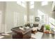 Elegant living room with soaring ceilings, plantation shutters, and a comfortable leather sofa at 5390 Chestnut Dr, Cumming, GA 30040