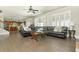 Open living area featuring hardwood floors, a leather sectional, and a view into the kitchen at 5390 Chestnut Dr, Cumming, GA 30040