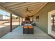 Beautiful patio with a stone fireplace, outdoor seating, and a ceiling fan at 5390 Chestnut Dr, Cumming, GA 30040