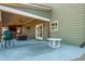 Relaxing covered patio with a built-in grill and ample seating for outdoor entertaining at 5390 Chestnut Dr, Cumming, GA 30040