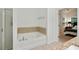 Bright bathroom with a bathtub and tile surround at 1519 Dolcetto Nw Trce # 1, Kennesaw, GA 30152