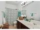 Well-lit bathroom with a decorative shower curtain, spacious vanity, and ample storage at 1519 Dolcetto Nw Trce # 1, Kennesaw, GA 30152