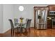 Cozy dining area adjacent to the kitchen, featuring a round glass table, stylish chairs, and stainless steel appliances at 1519 Dolcetto Nw Trce # 1, Kennesaw, GA 30152