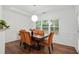 Bright dining room features a modern light fixture, a wood table, and paneled walls at 1519 Dolcetto Nw Trce # 1, Kennesaw, GA 30152