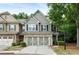 Charming two-story townhome with attached two-car garage, neutral siding and brick accents with mature trees at 1519 Dolcetto Nw Trce # 1, Kennesaw, GA 30152