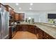 Well-equipped kitchen featuring stainless steel appliances, granite countertops, and stylish wooden cabinetry with hardwood floor at 1519 Dolcetto Nw Trce # 1, Kennesaw, GA 30152