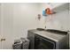 Functional laundry area with modern washer and dryer, shelving, and organizers at 1519 Dolcetto Nw Trce # 1, Kennesaw, GA 30152