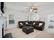 Spacious living room with a plush sectional sofa, fireplace, and ample natural light, adjacent to an open doorway at 1519 Dolcetto Nw Trce # 1, Kennesaw, GA 30152