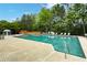 Community pool with ample lounge chairs, a tanning deck, and lush surroundings at 1519 Dolcetto Nw Trce # 1, Kennesaw, GA 30152