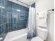 Bathroom featuring blue tile, a shower-tub combo and a white vanity at 2693 Greentree Se Dr, Marietta, GA 30067