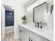 Bathroom with updated vanity, dark fixtures and a shower with tiled walls at 2693 Greentree Se Dr, Marietta, GA 30067