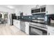 Modern kitchen with stainless steel appliances, sleek countertops, and a view into the dining area at 2693 Greentree Se Dr, Marietta, GA 30067
