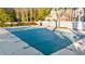 Community pool covered for the off-season, surrounded by mature trees, providing a private and peaceful recreational area at 2693 Greentree Se Dr, Marietta, GA 30067